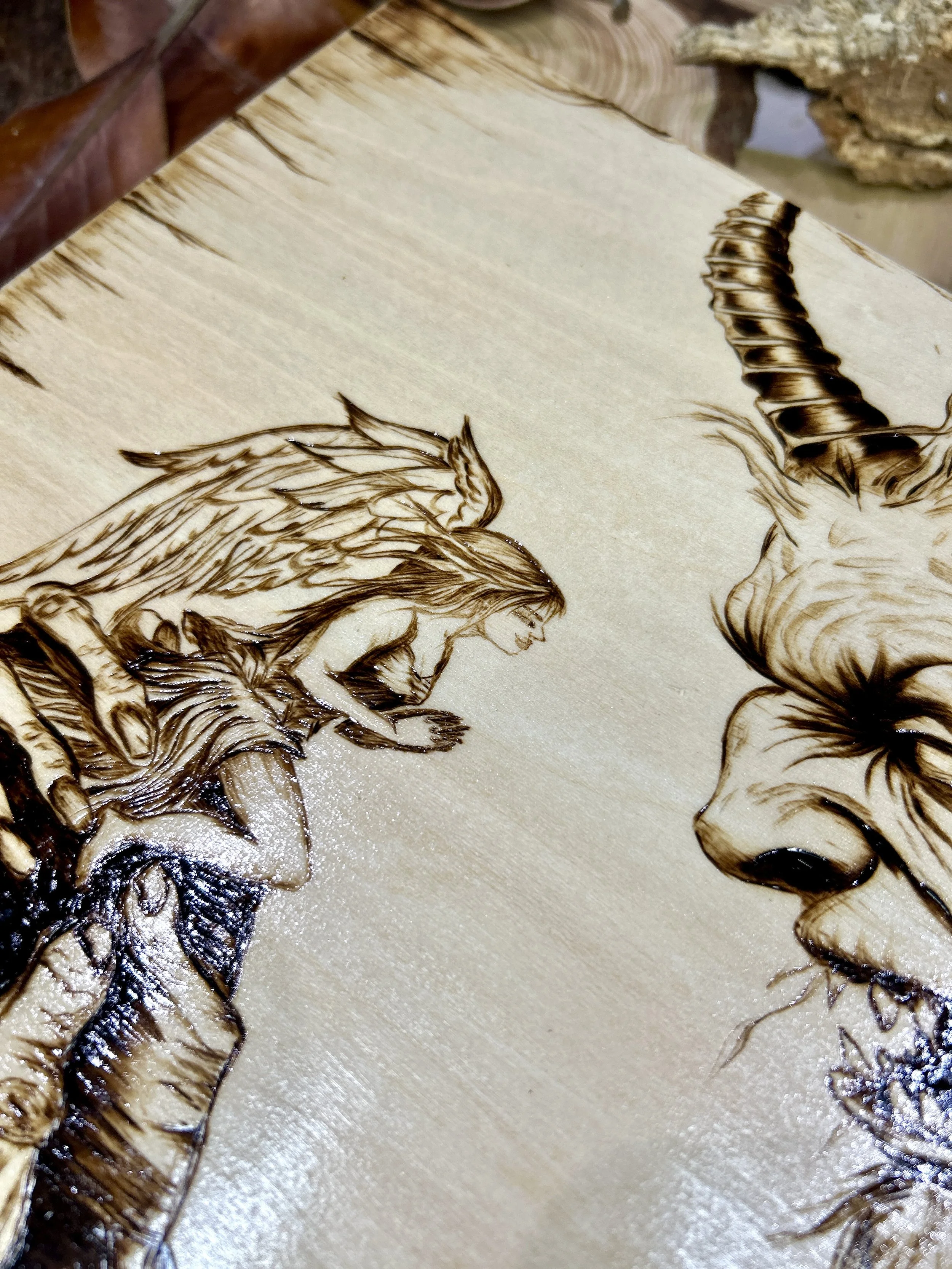 Collection of wood-burned pyrography artworks featuring angels and demons, showcasing handcrafted fantasy art in unique, artisan, one-of-a-kind designs and decor