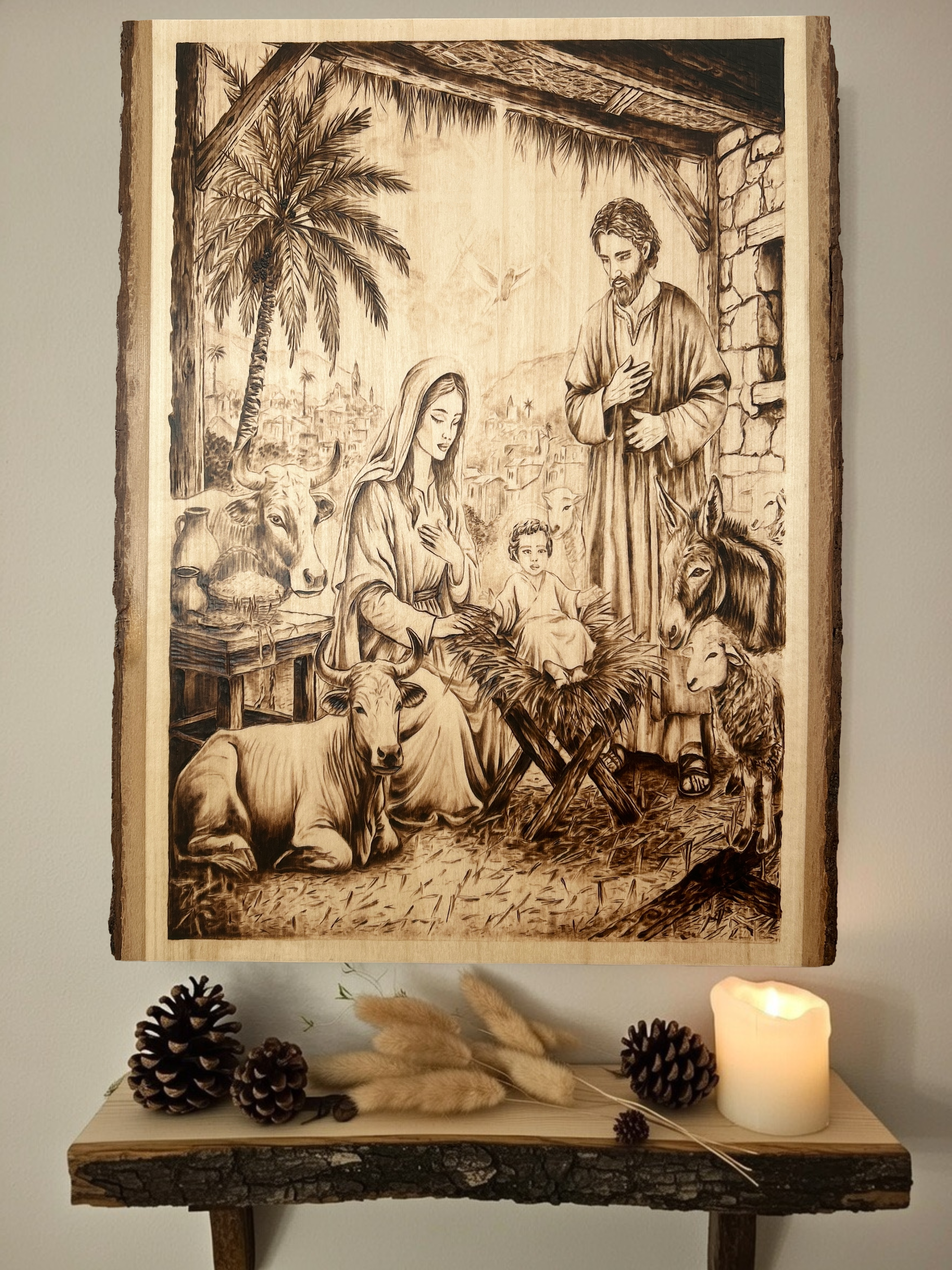 Nativity scene on a rectangular panel, featuring the Holy Family and stable animals in a traditional pyrography style.