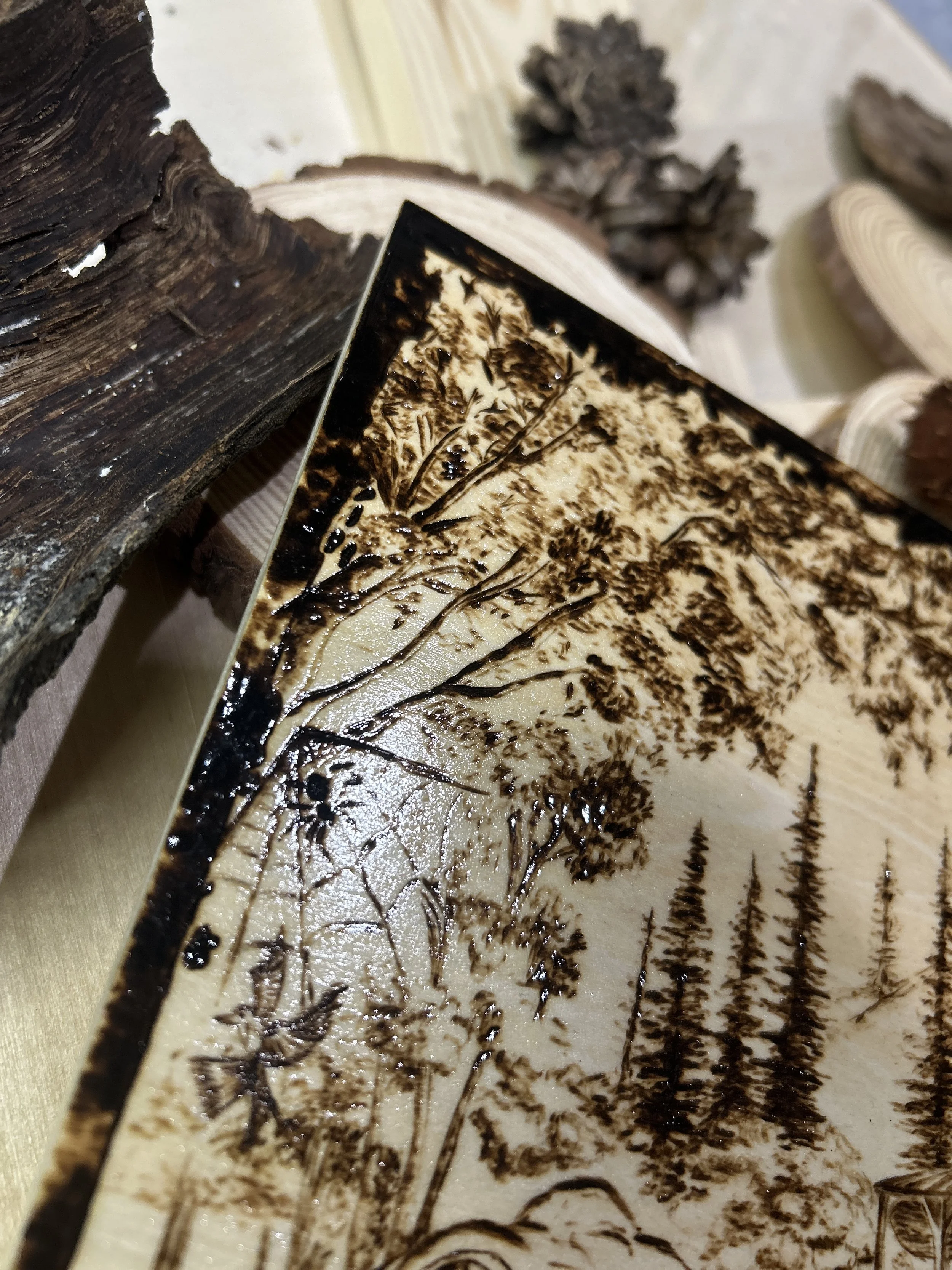 Collection of wood-burned pyrography artworks showcasing handcrafted fantasy art in unique, artisan, one-of-a-kind designs and decor, featuring detailed Dusk Hollow scenes on natural wood
