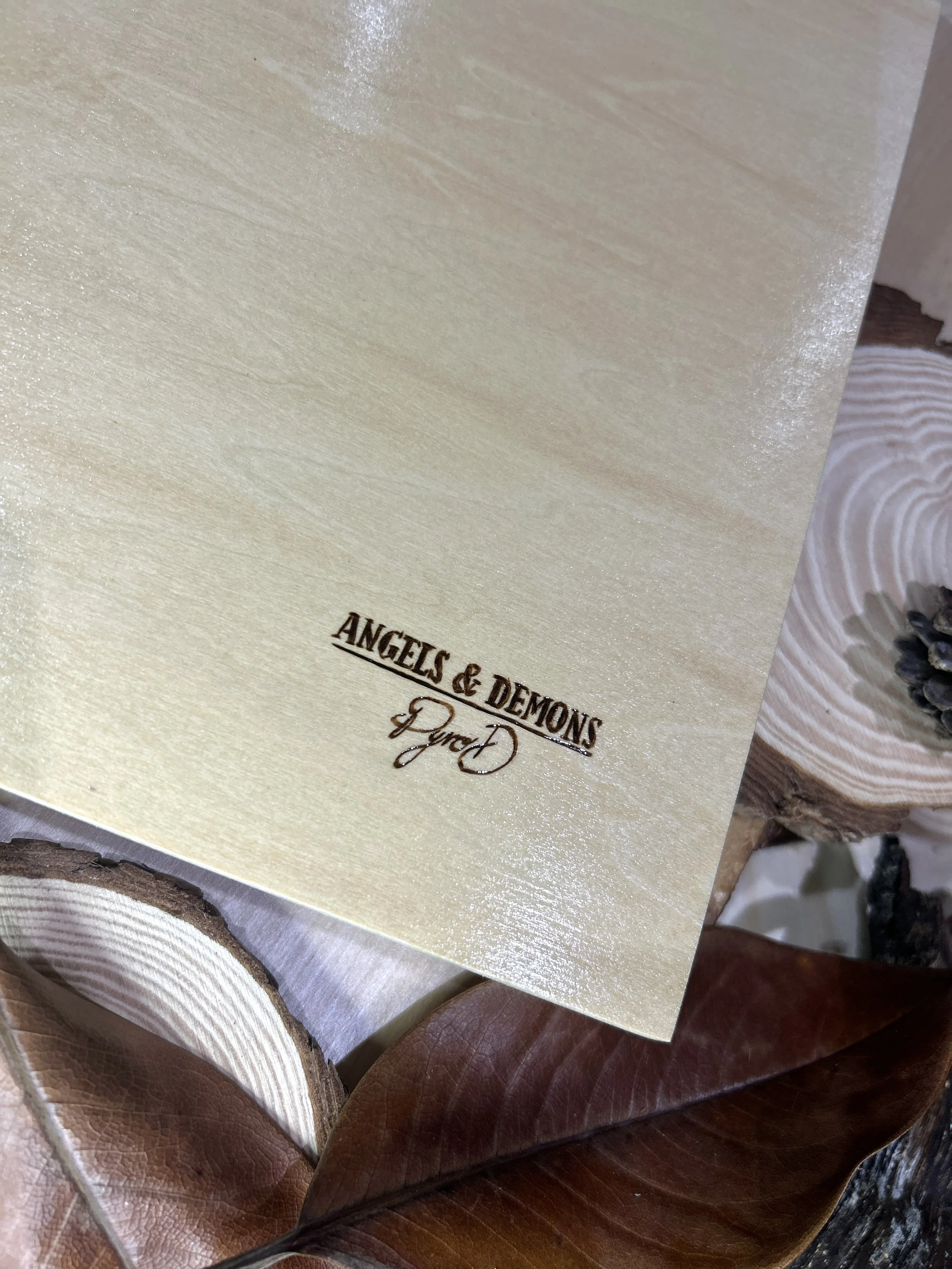 Collection of wood-burned pyrography artworks featuring angels and demons, showcasing handcrafted fantasy art in unique, artisan, one-of-a-kind designs and decor