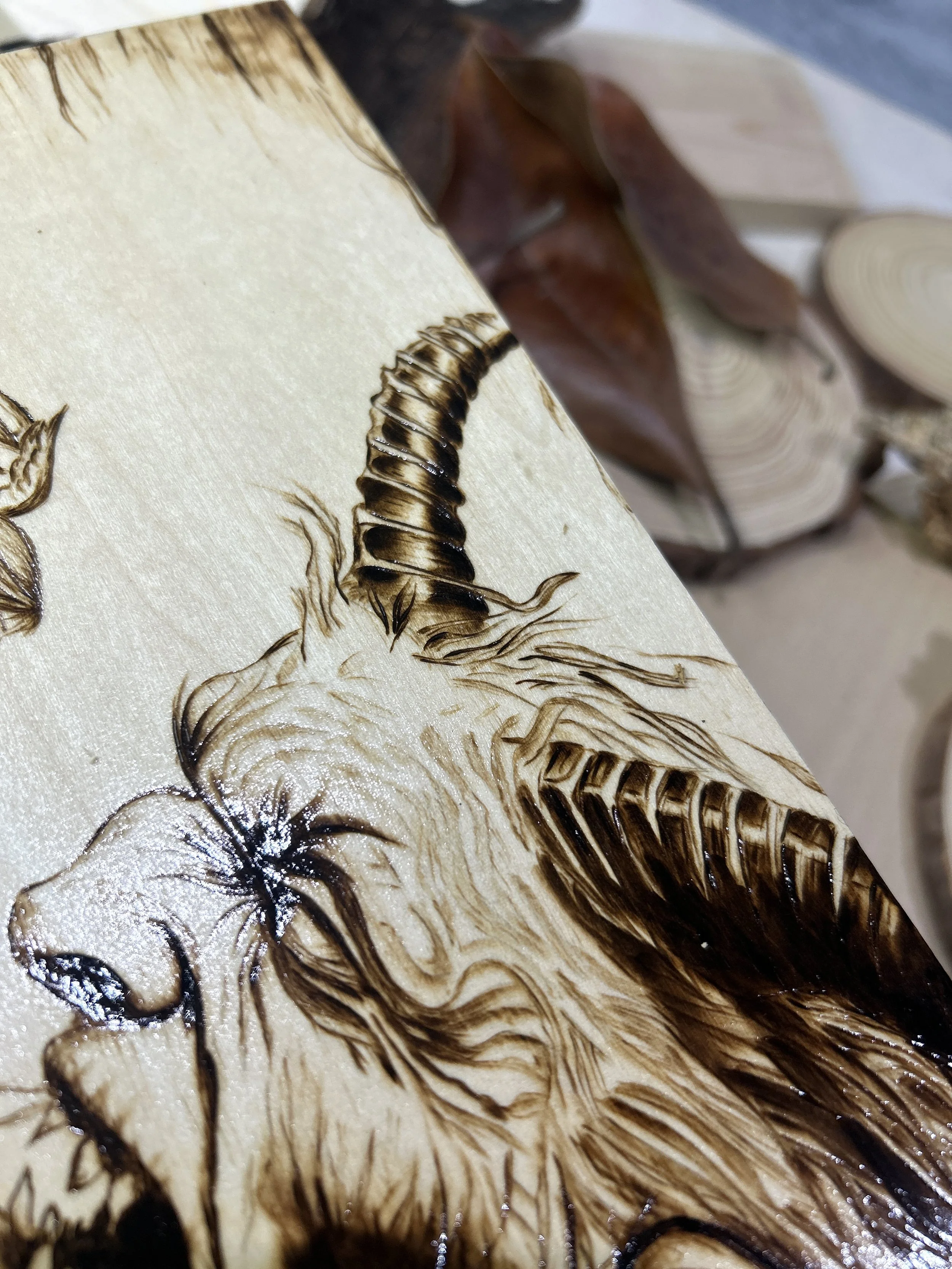 Collection of wood-burned pyrography artworks featuring angels and demons, showcasing handcrafted fantasy art in unique, artisan, one-of-a-kind designs and decor