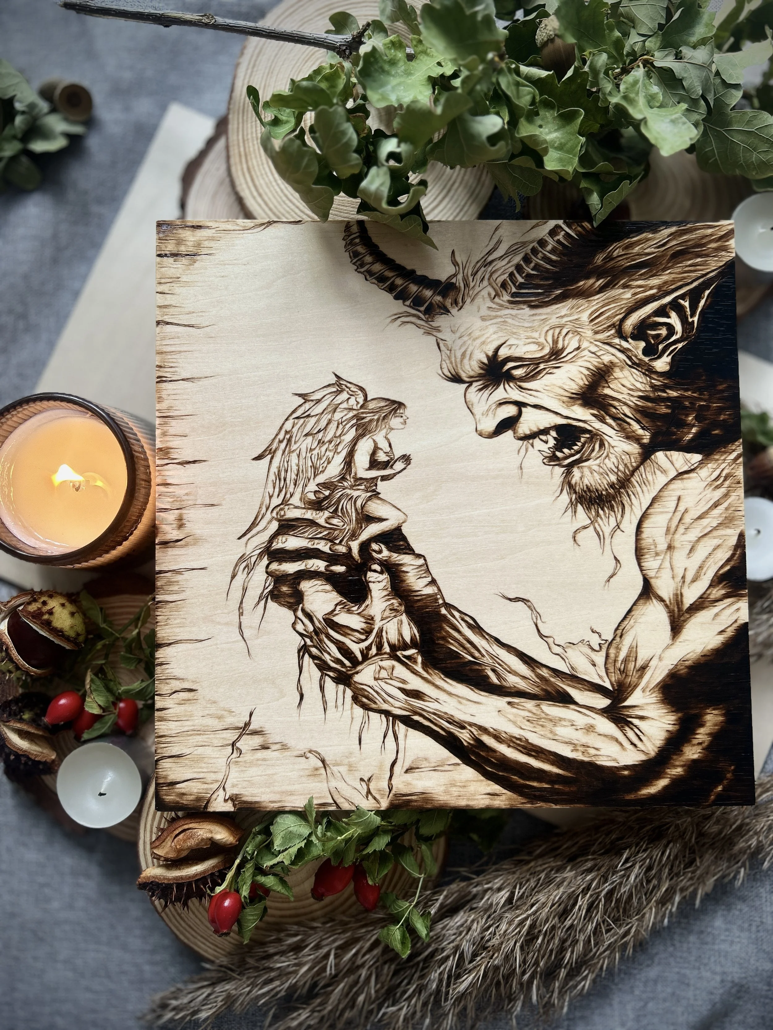 Collection of wood-burned pyrography artworks featuring angels and demons, showcasing handcrafted fantasy art in unique, artisan, one-of-a-kind designs and decor