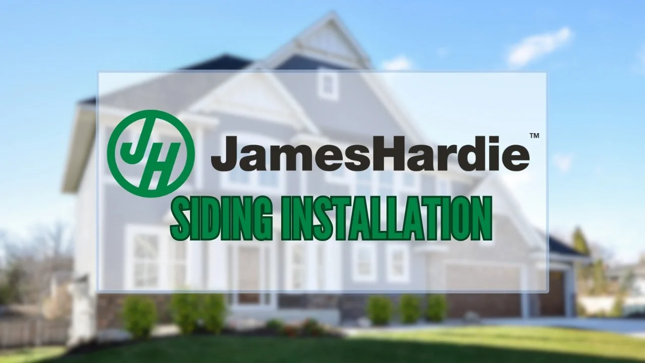 A man in a blue sweater and beige pants sits on a cushioned bench, looking to his left with a relaxed expression, casting a shadow on the beige wall behind him.