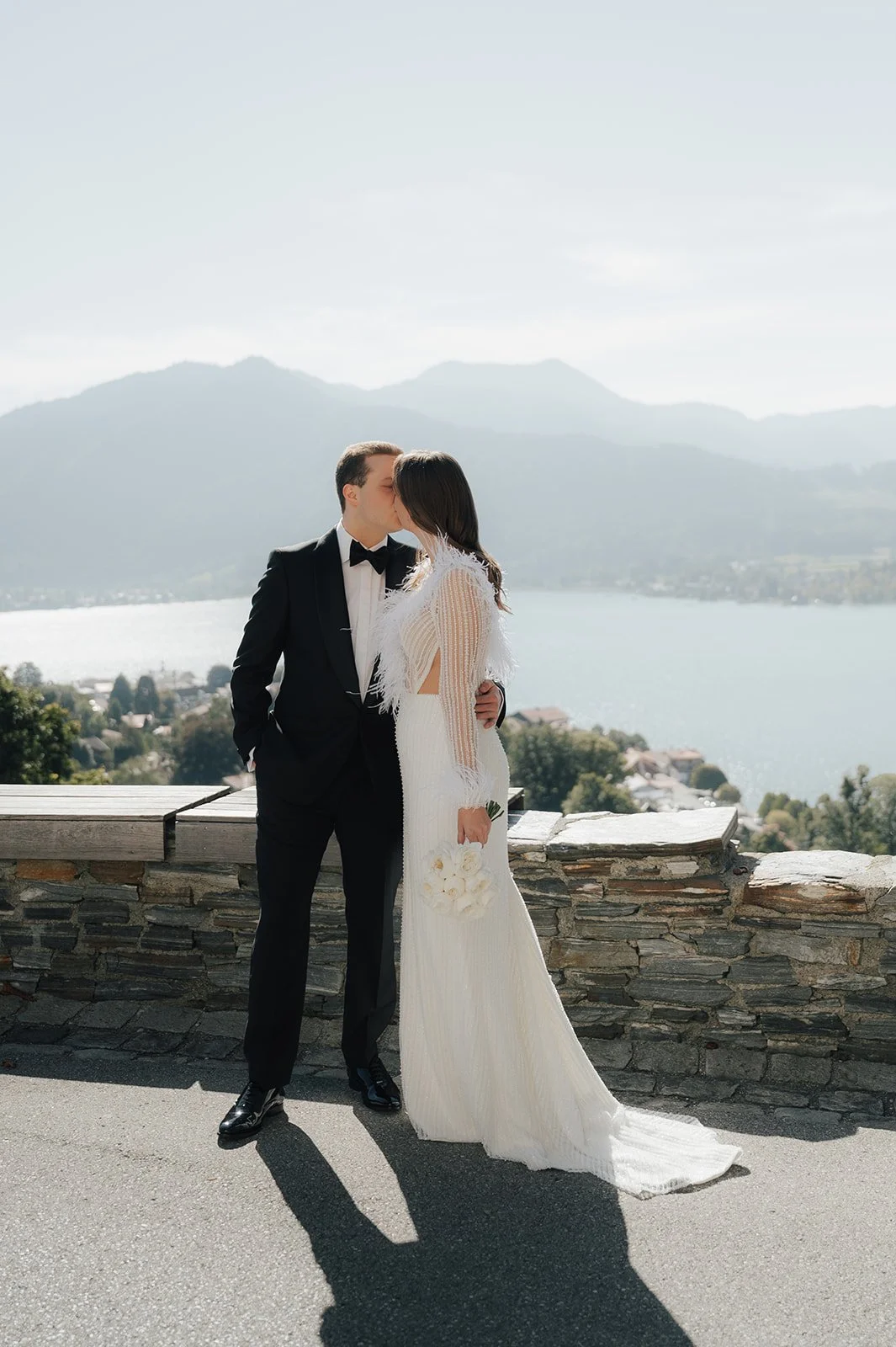 luxury destination wedding couple overlooking Tegernsee with mountain backdrop