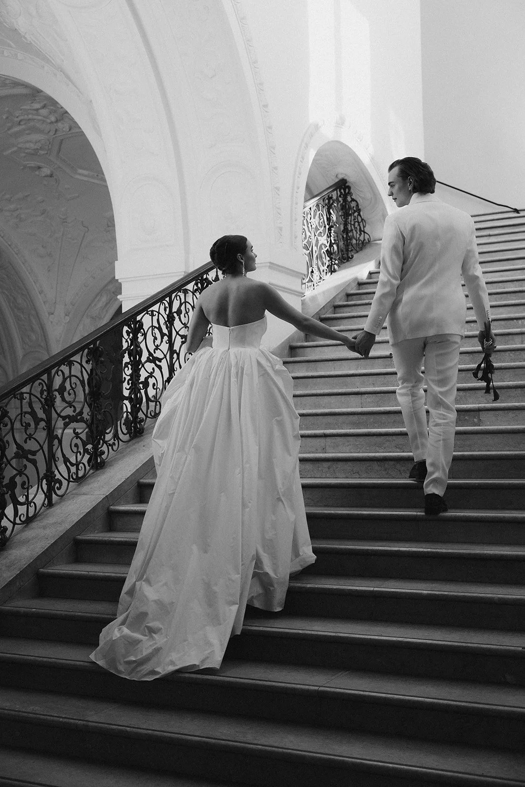 editorial wedding couple on a grand staircase captured in black and white
