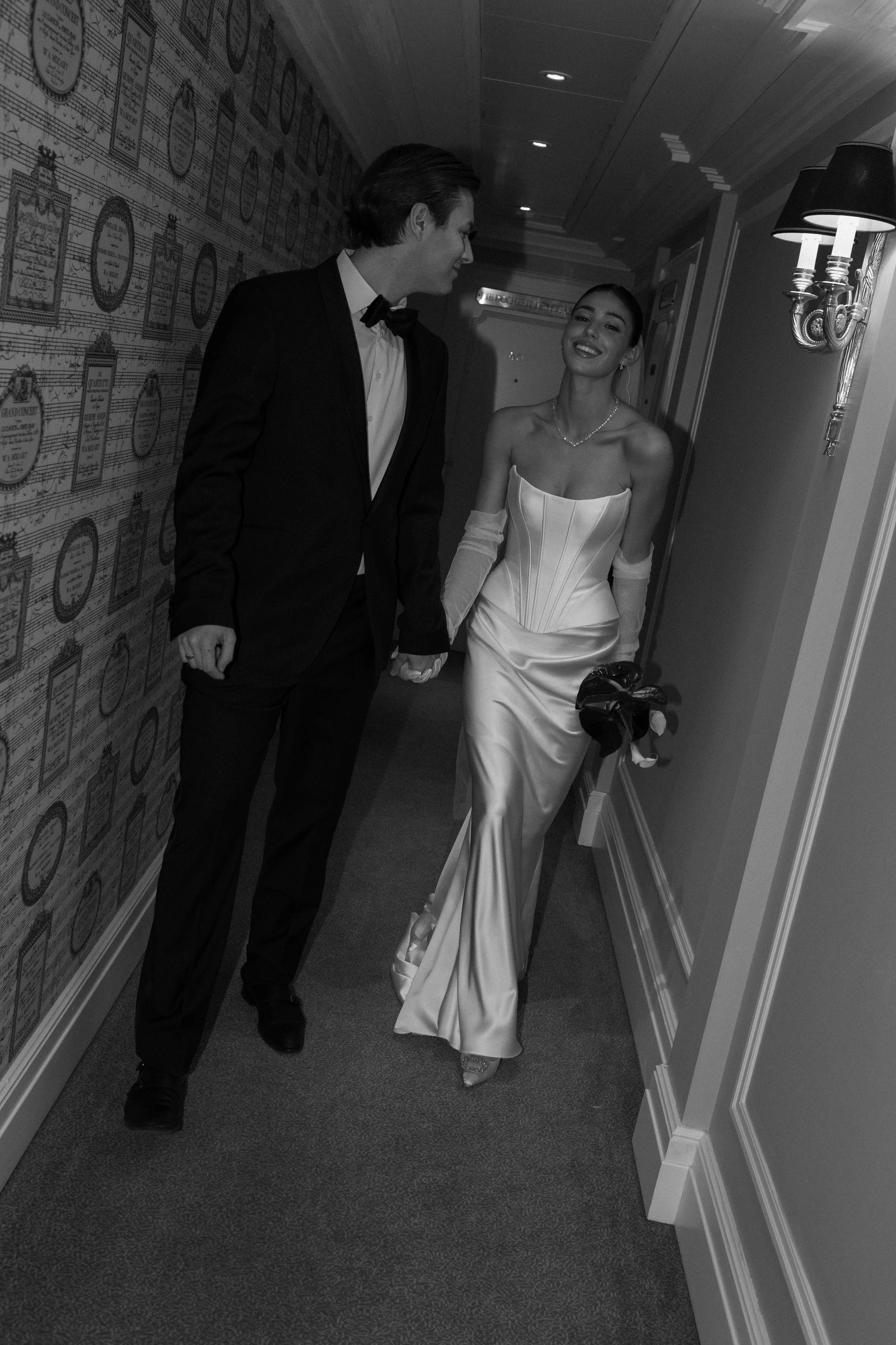 editorial wedding couple walking together during an evening celebration