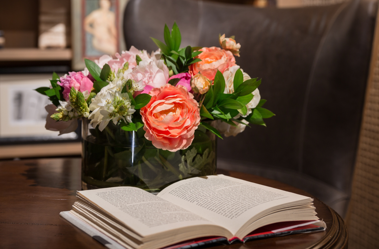 Floral Arrangement and Open Book on Coffee Table (Copy)