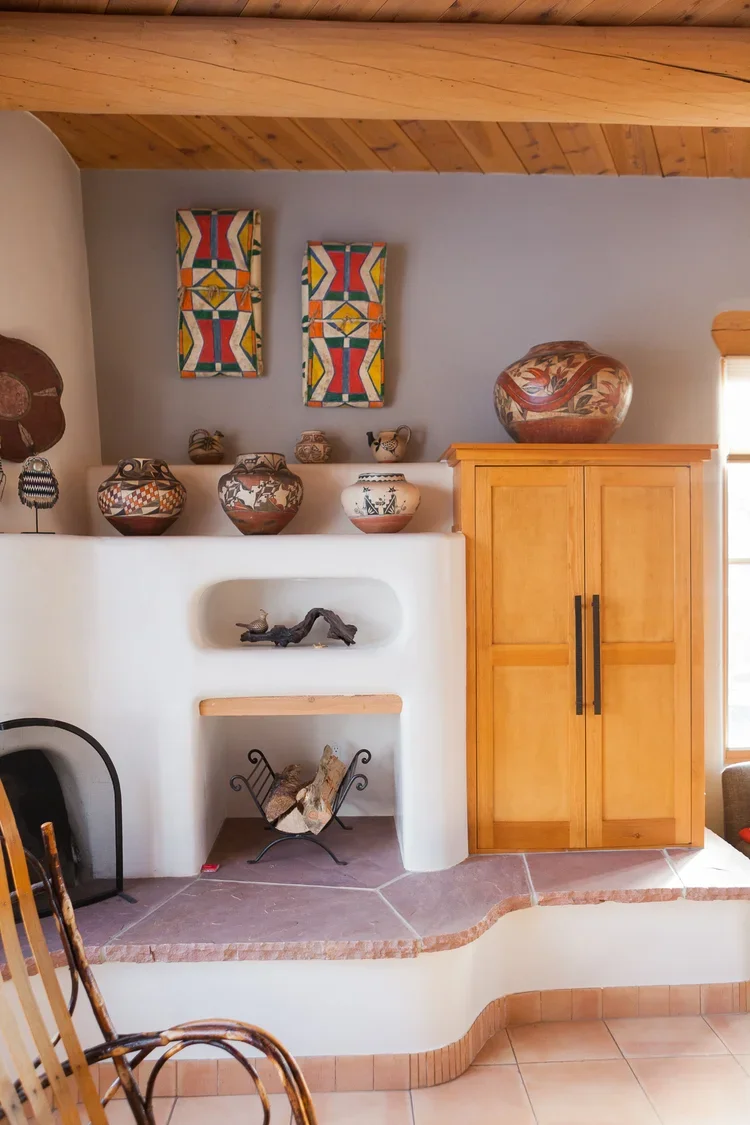 Southwestern Fireplace Niche with Built-In Shelving and Wood Cabinet