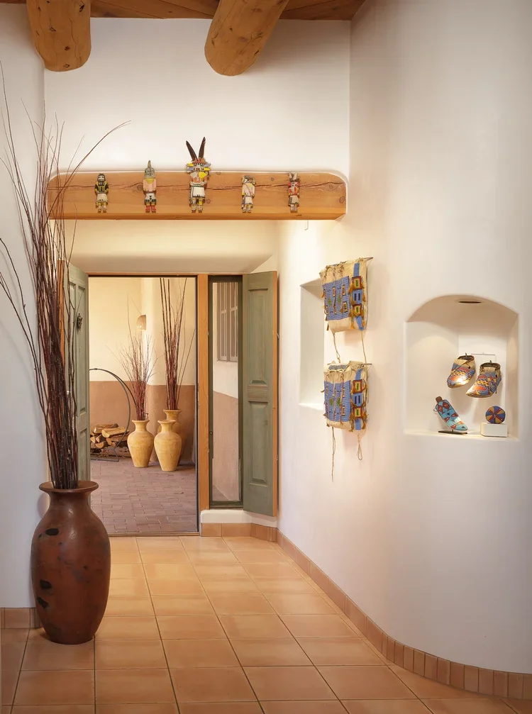 Southwestern Entry Hallway with Wood Beams and Decorative Niches