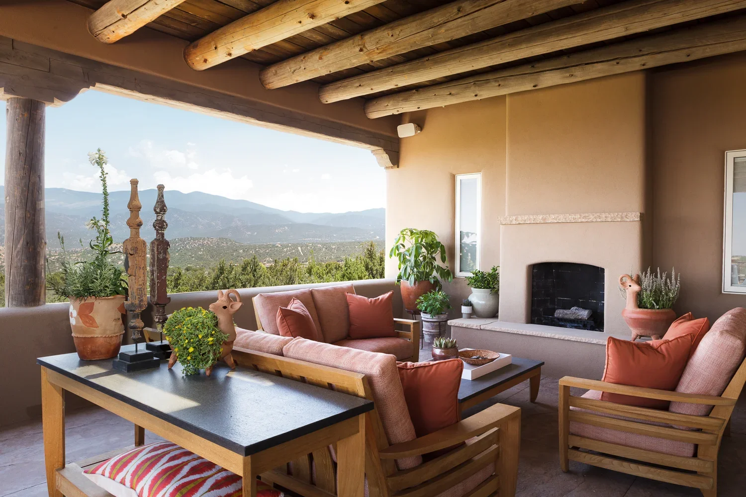 Southwestern Outdoor Living Area with Fireplace and Mountain Views