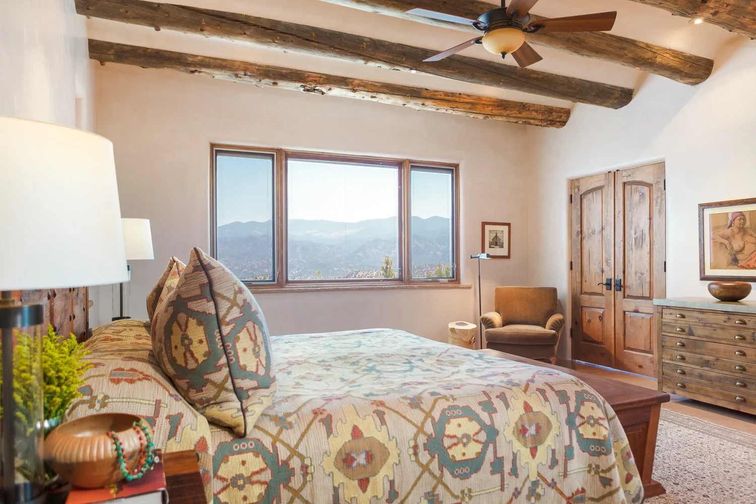 Southwestern Bedroom with Exposed Wood Beams and Patterned Bedding
