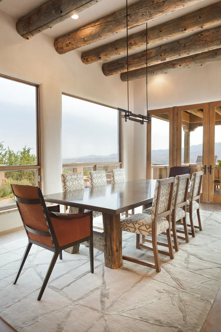 Dining Area with Exposed Wood Beams and Scenic Window Views