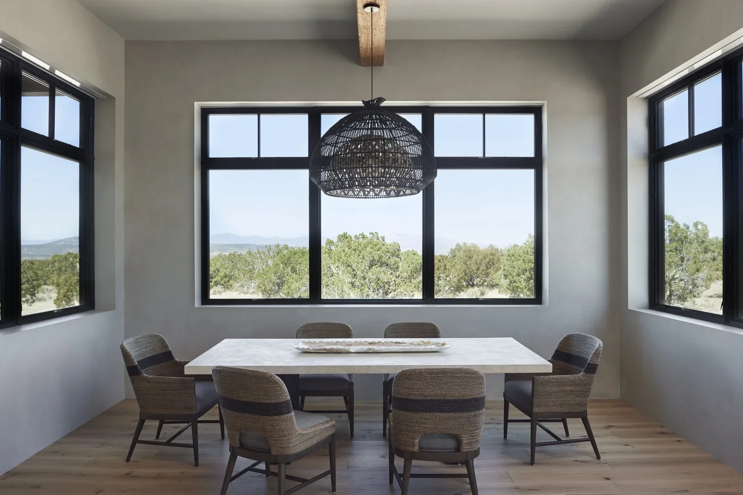 Dining Room with Large Windows and Woven Pendant Light