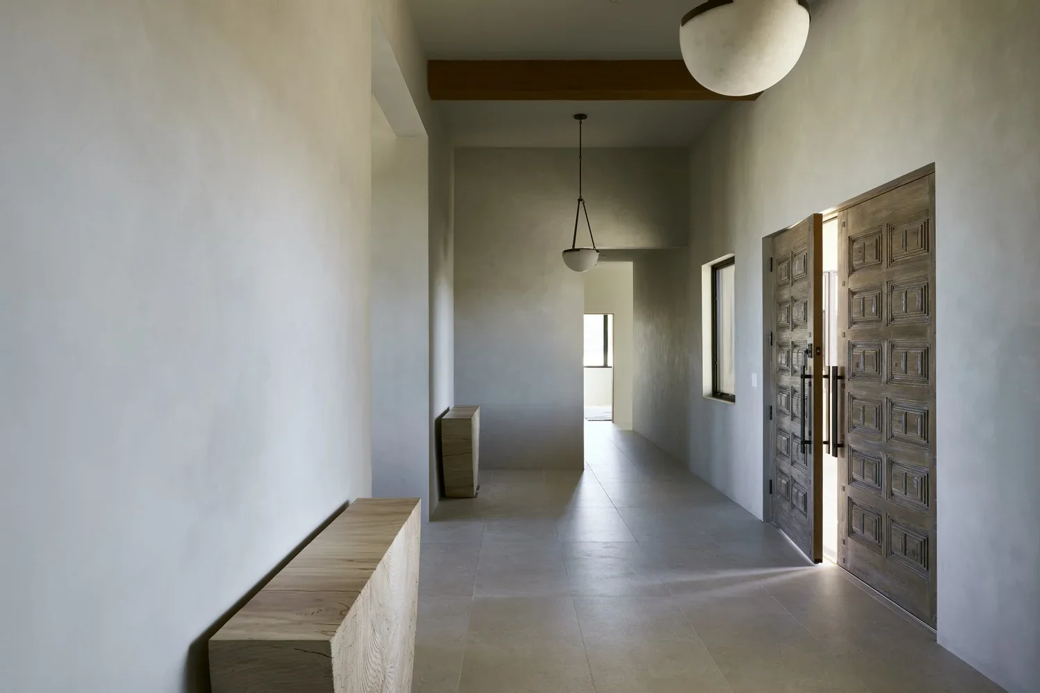 Minimalist Hallway with Natural Wood Storage and Decorative Wall Panels