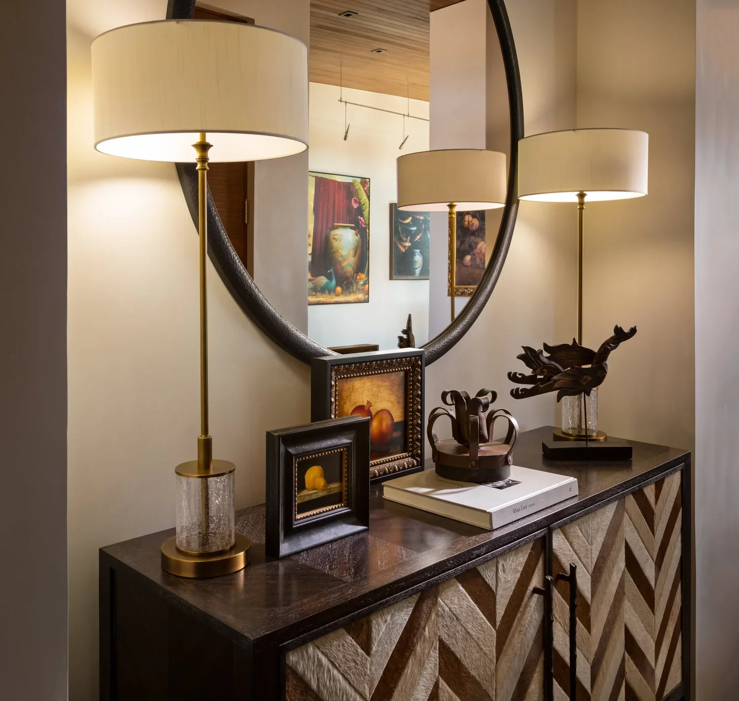 Styled Console Table with Brass Lamps and Decorative Accents