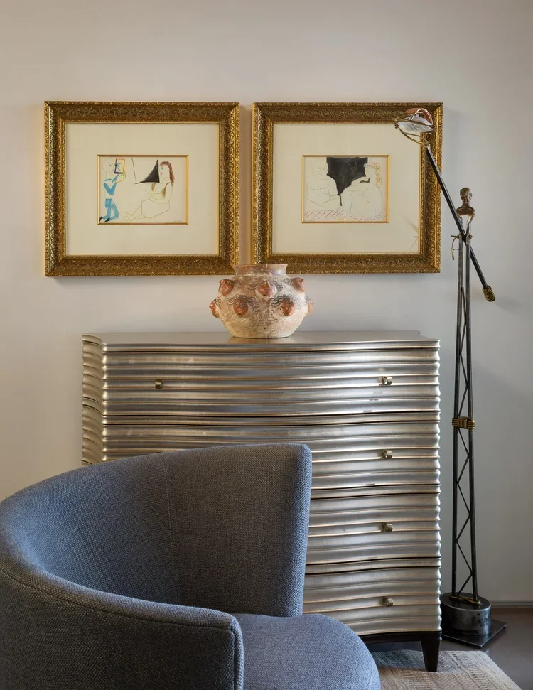 Elegant Corner with Metallic Chest and Framed Artwork