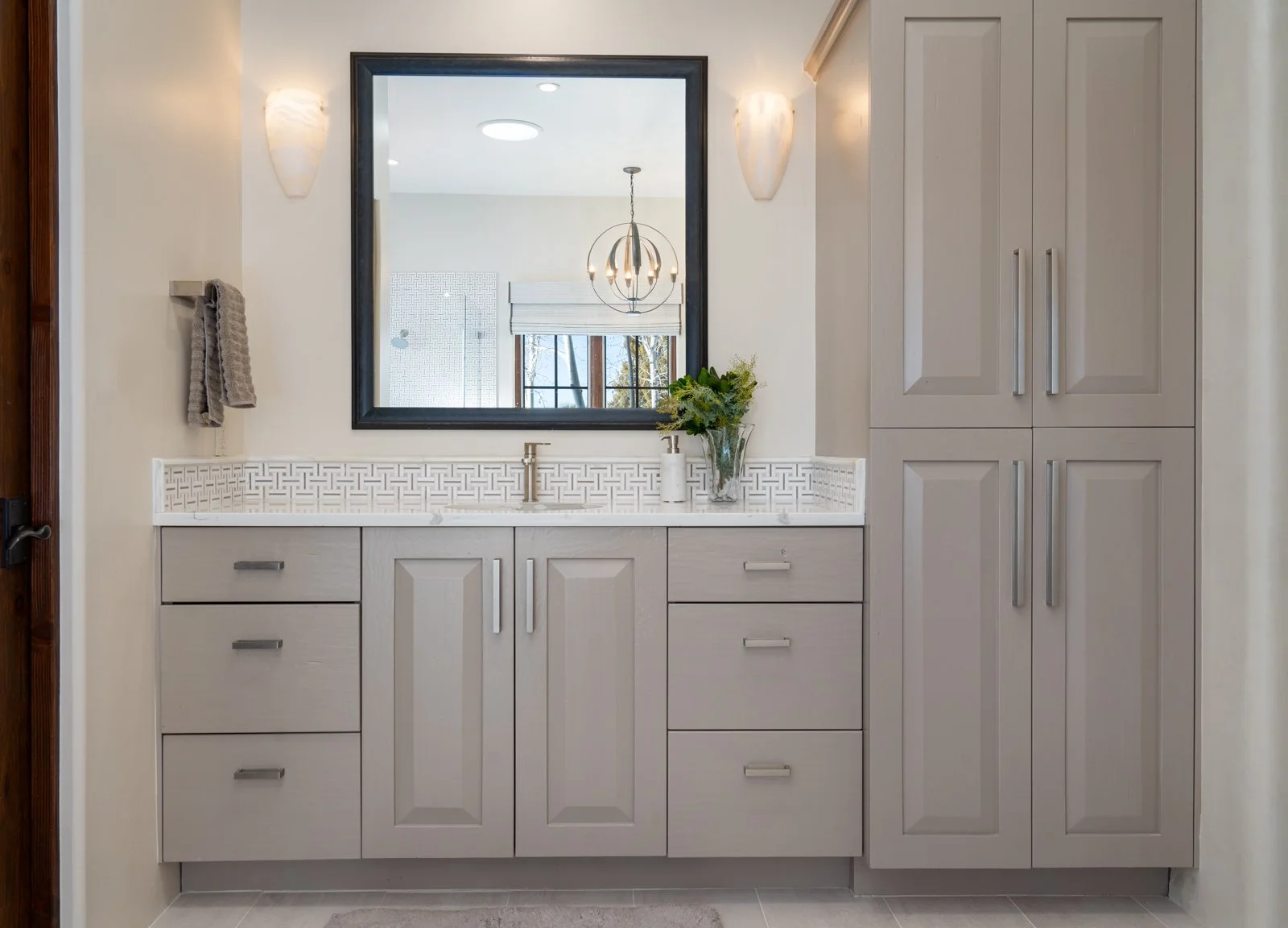 Elegant Double Vanity Bathroom with Custom Cabinetry and Wall Sconces