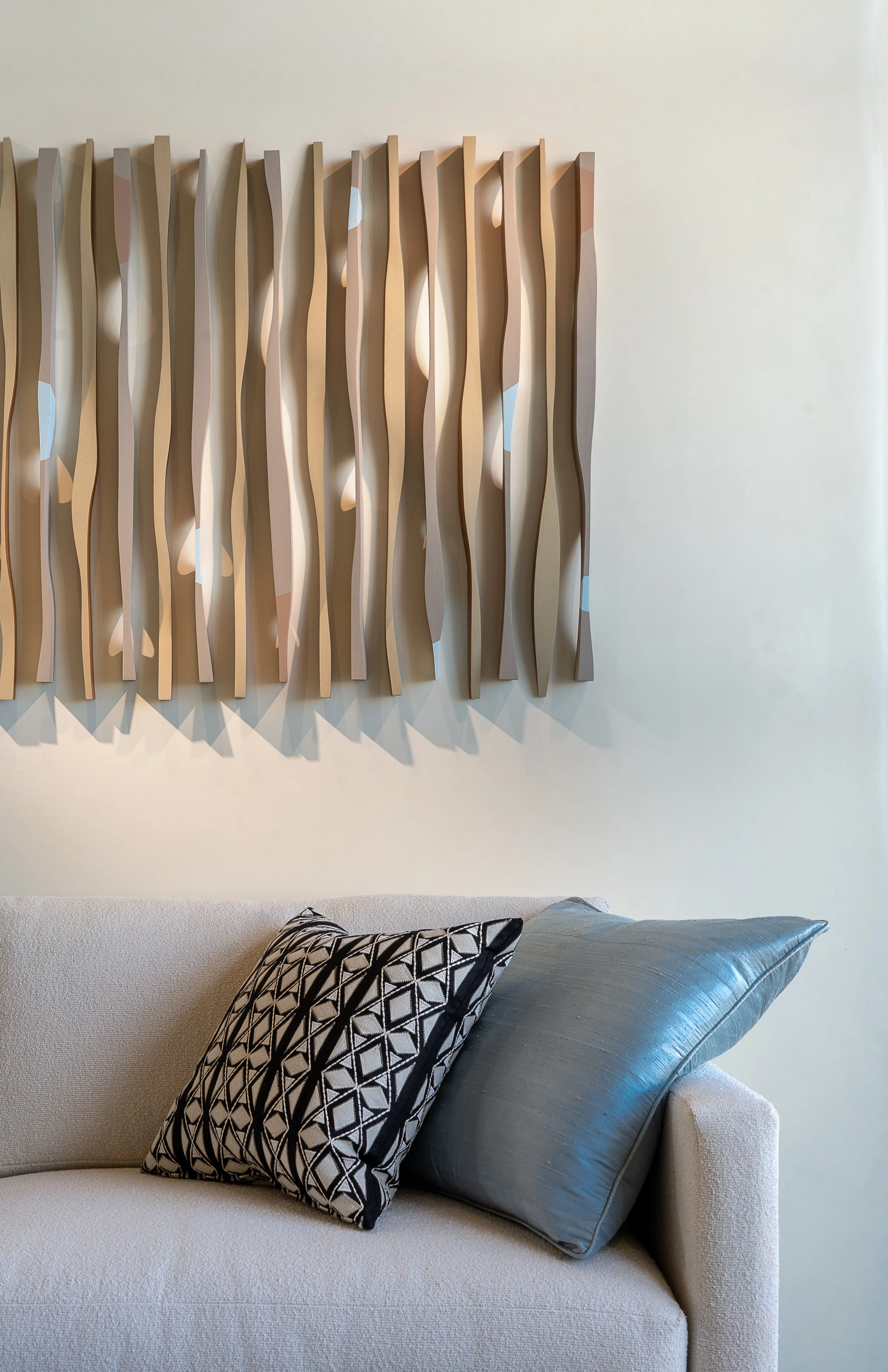 Modern Abstract Wood Wall Art Above Neutral Sofa