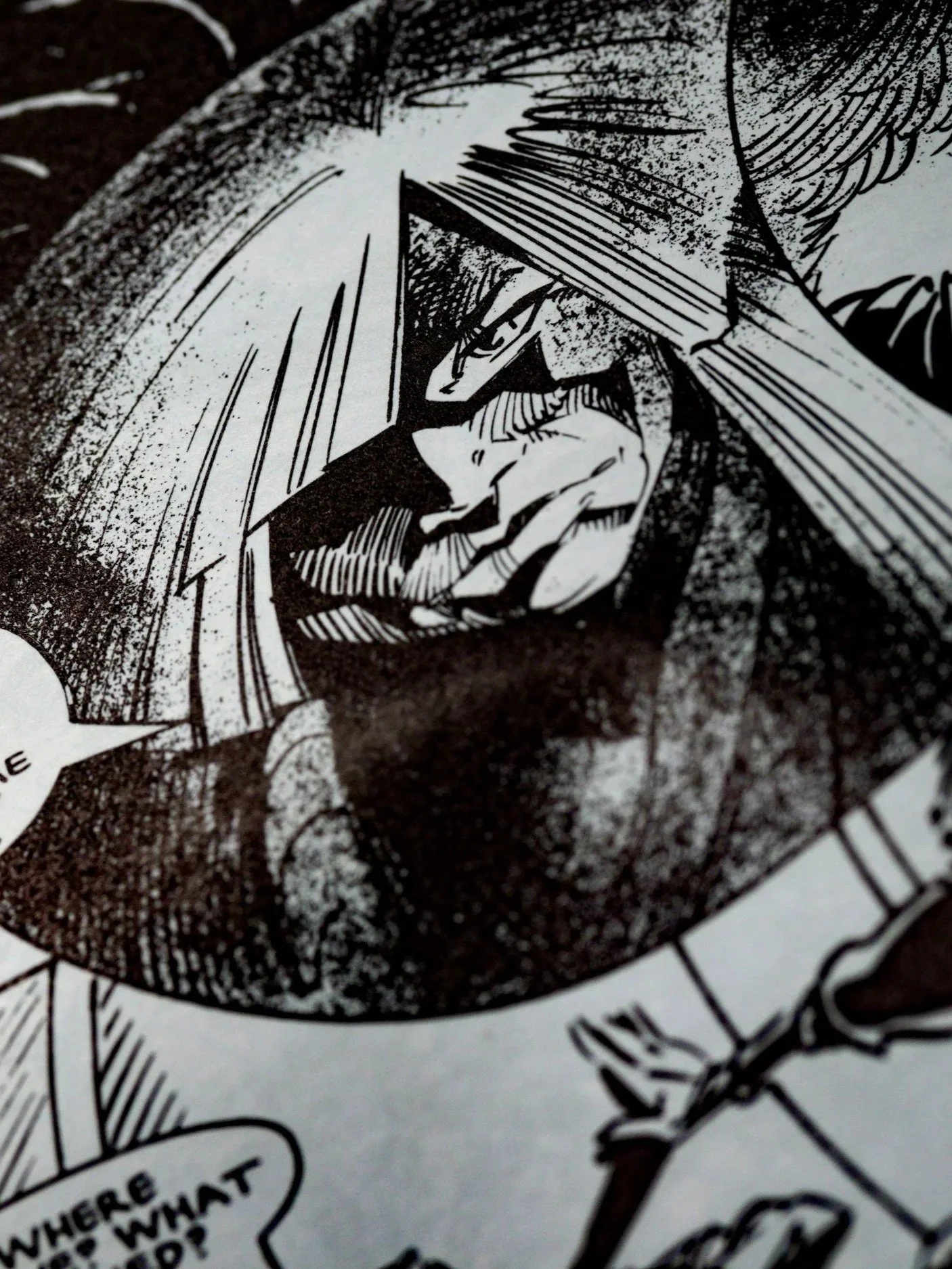 Close-up of a black and white comic book drawing featuring a warrior with a helmet, rugged face, and grim expression.