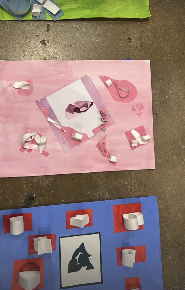 Colorful collage board with paper cutouts and curled paper strips arranged on a pink background, featuring a silhouette of two wolves howling, and a blue background with paper shapes decorated with red and black accents.