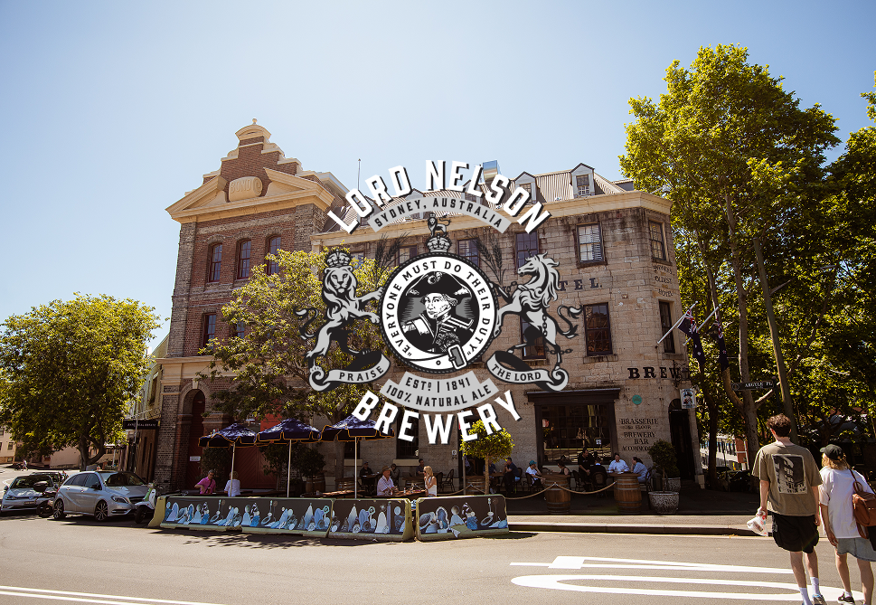 A historic brick building in Sydney, Australia, with a sign for Lord Nelson Brewery over the street.