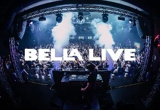 Stage at a live concert with blue lighting, smoke effects, and the words 'BELLA LIVE' displayed prominently.