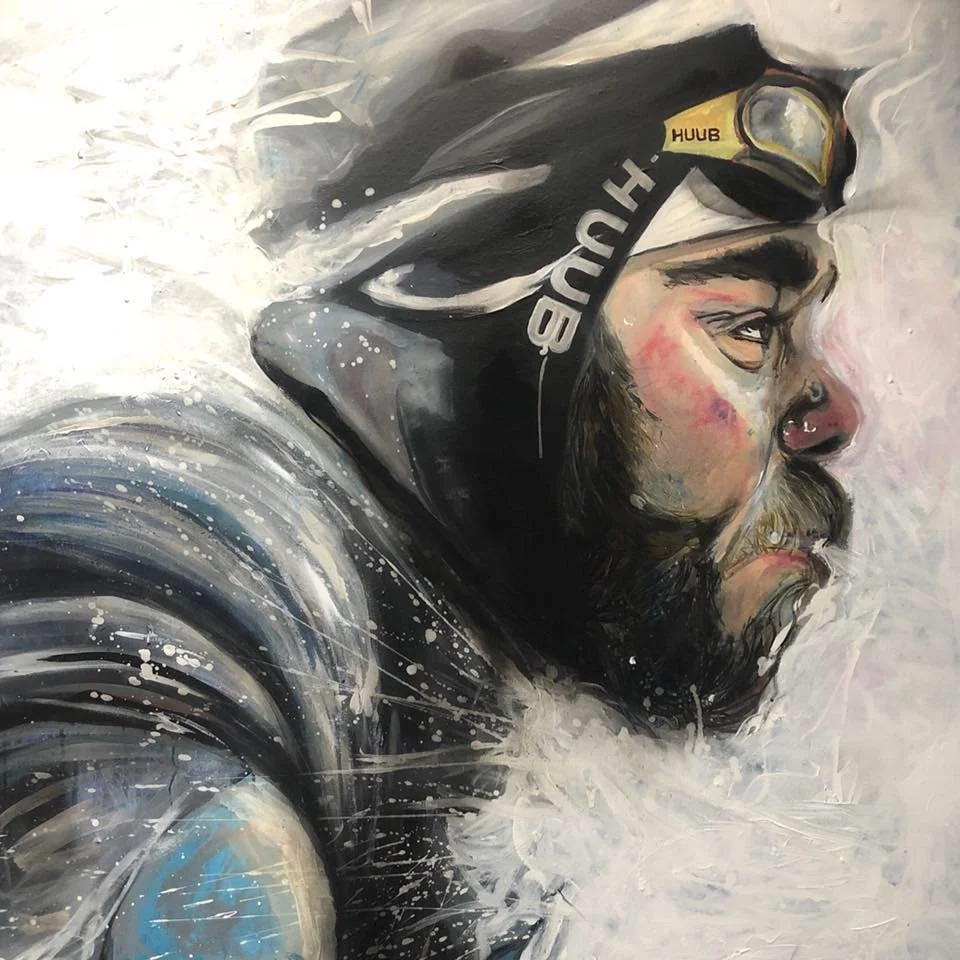 A painting of a man wearing a black hoodie and a yellow helmet, with a beard and nose piercing, looking to the right. The artwork uses bold brush strokes, splashes, and a monochrome and colorful palette.