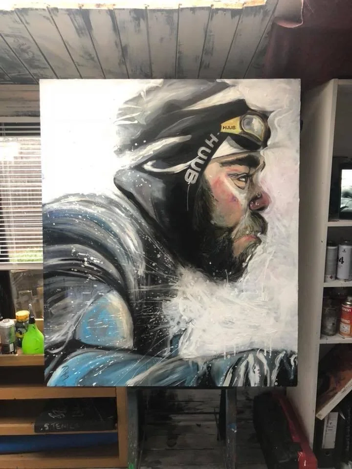 A painting of a man wearing a headlamp and cold weather gear, seen from the side, with a beard and intense expression.