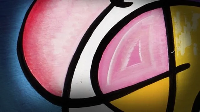 Close-up of a colorful abstract mural with bold black outlines, pink, yellow, and blue sections.