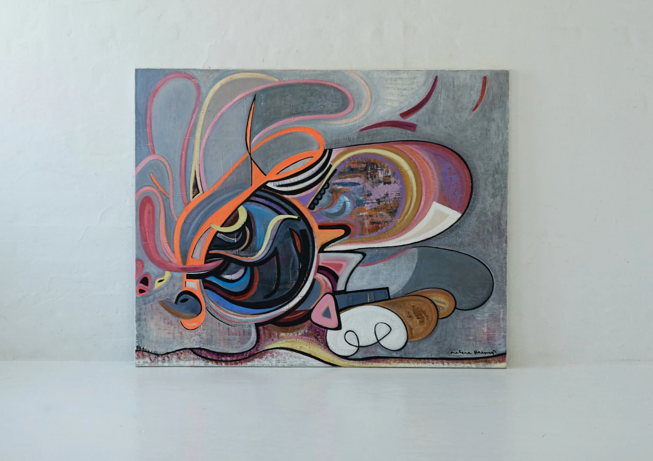 Abstract colorful painting with swirls, lines, and shapes on a gray background, displayed on a wall.