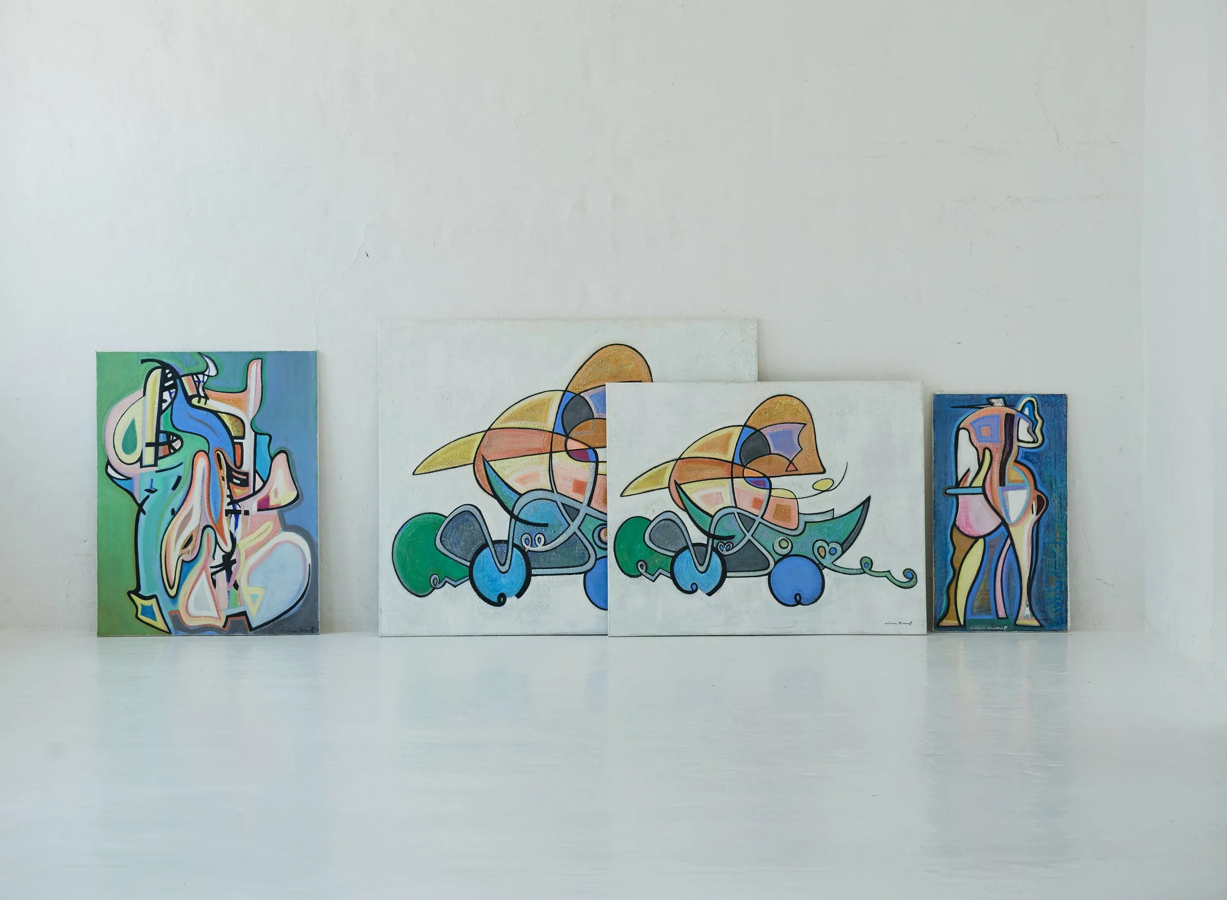 Four colorful abstract paintings on a white gallery wall, each featuring geometric and organic shapes in vibrant colors.