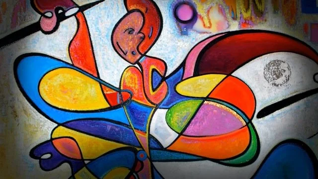 Colorful abstract graffiti art featuring a figure and various shapes and colors.