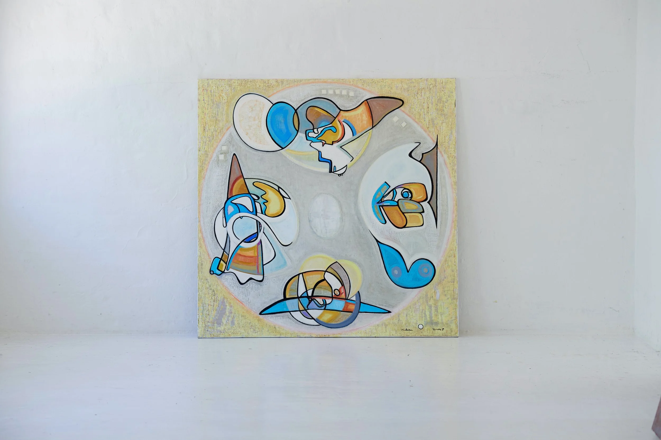 Abstract colorful painting on a wall with various shapes and lines in blue, yellow, orange, and black, surrounded by a circular border.