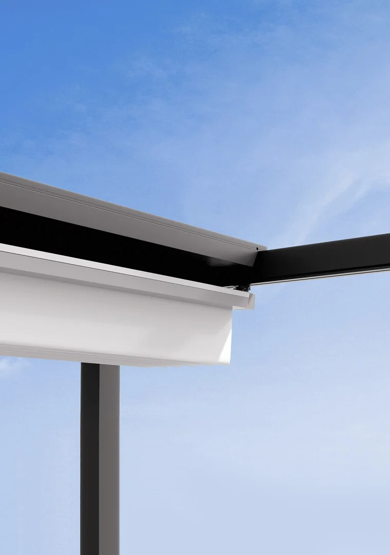 Close-up of a modern building's overhang against a blue sky, showcasing clean lines and minimalistic design.