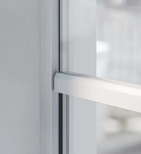 Close-up of a sliding glass door with a white frame.