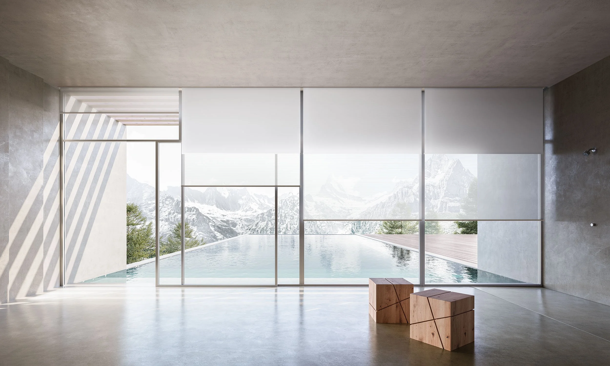 Modern interior room with large floor-to-ceiling windows overlooking mountains and a body of water.