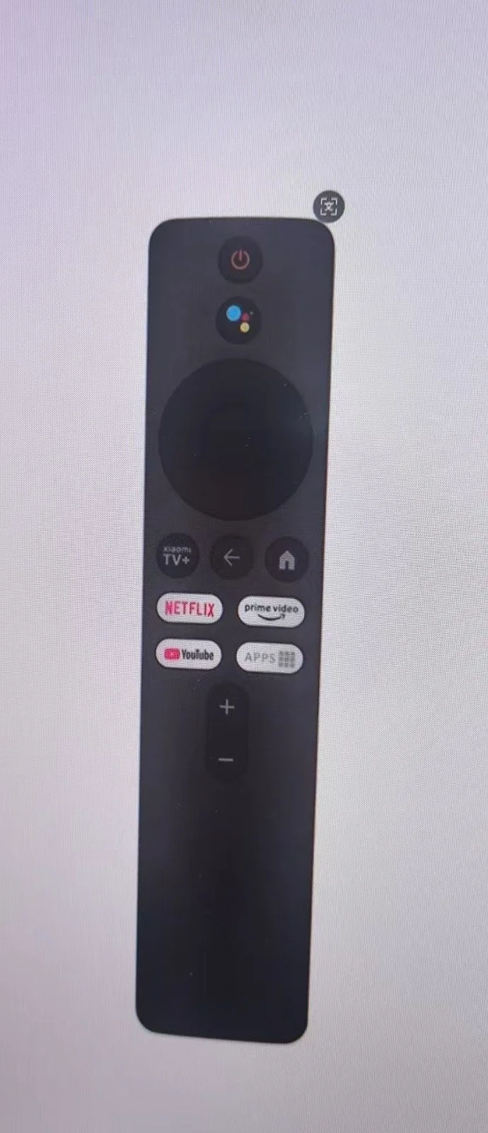 Télécarteur noir avec plusieurs boutons, y compris Netflix, YouTube, Prime Video, une touche de navigation, et un bouton d'alimentation.