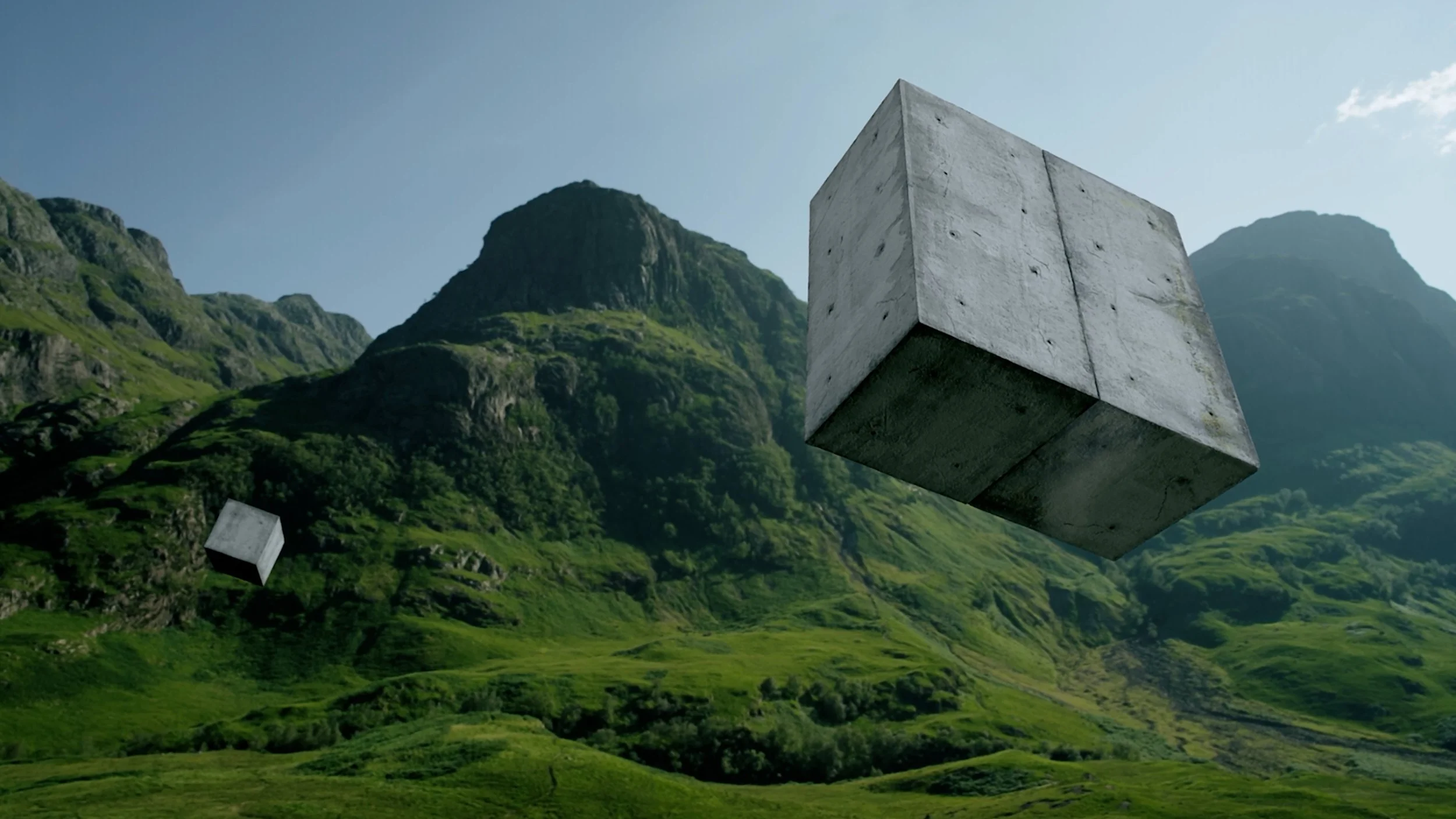 Two large concrete cubes floating above a lush green mountainous landscape on a clear day.