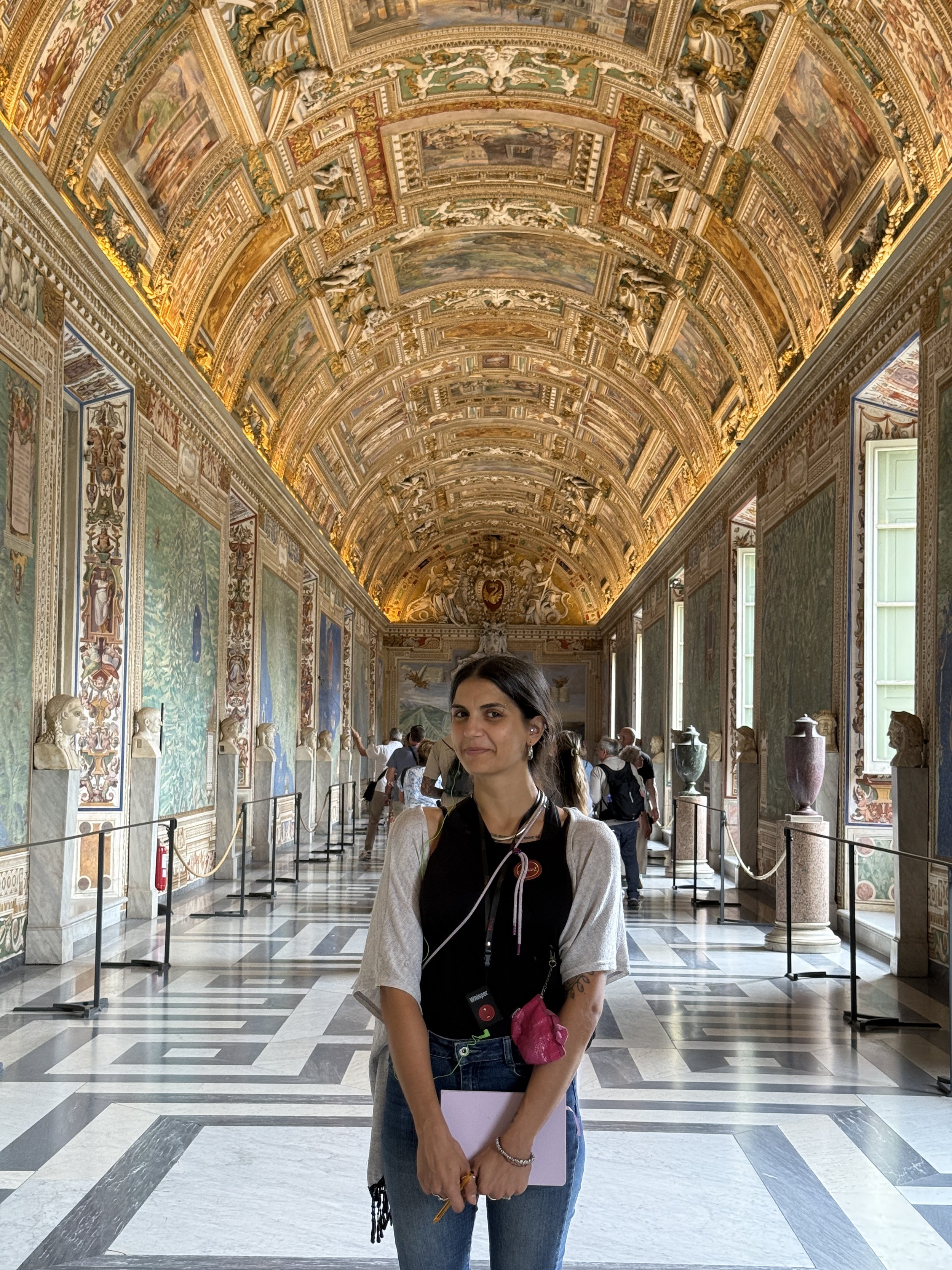People viewing the Sistine Chapel ceiling and wall paintings inside the Vatican Museums in Vatican City.