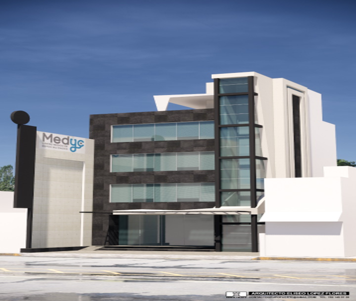 Edificio moderno con fachada de cristal y paredes blancas y negras, con cartel que dice 'Medyc'.