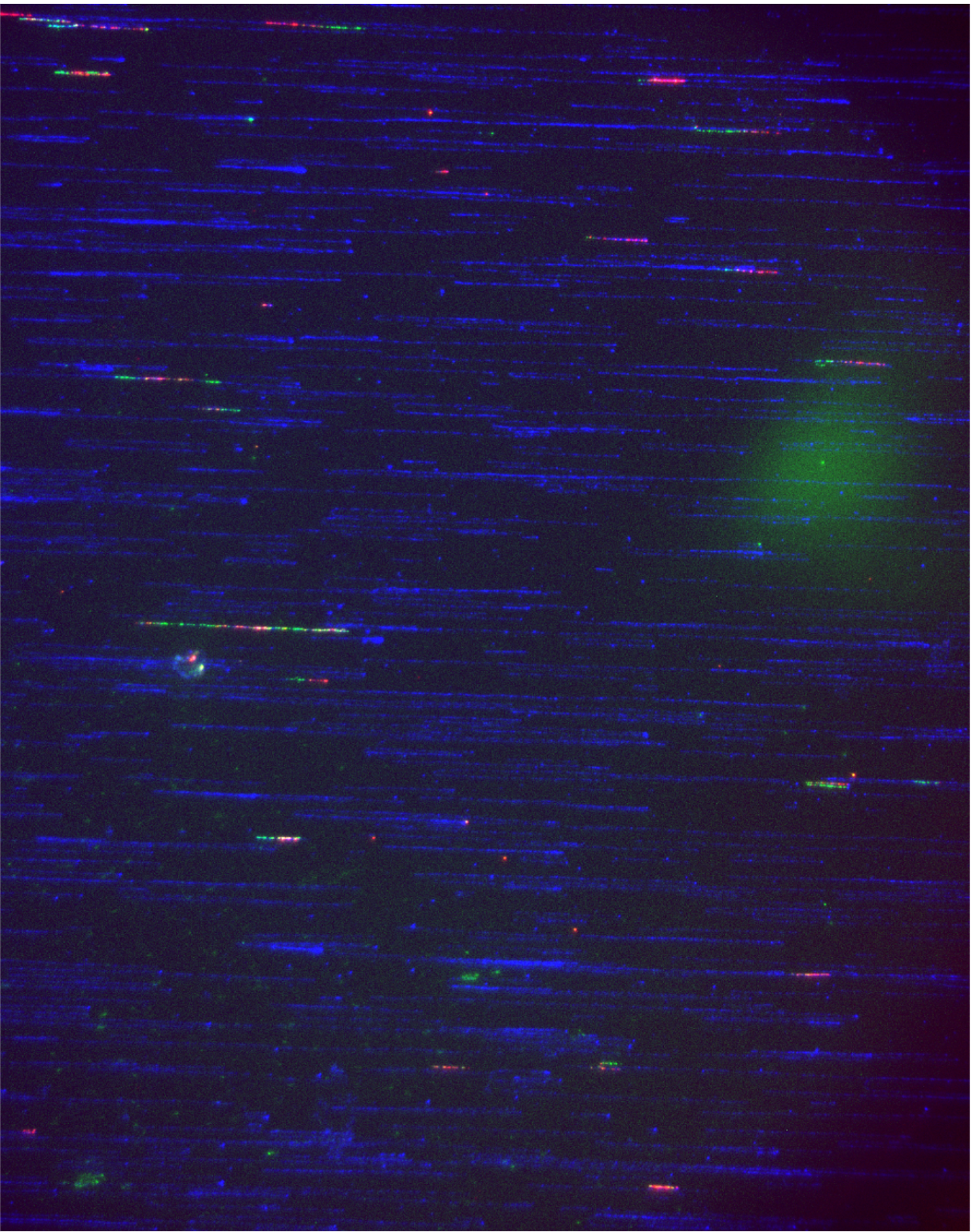 Colorful light streaks against a dark background, resembling a starry night sky or long exposure photo of moving lights.