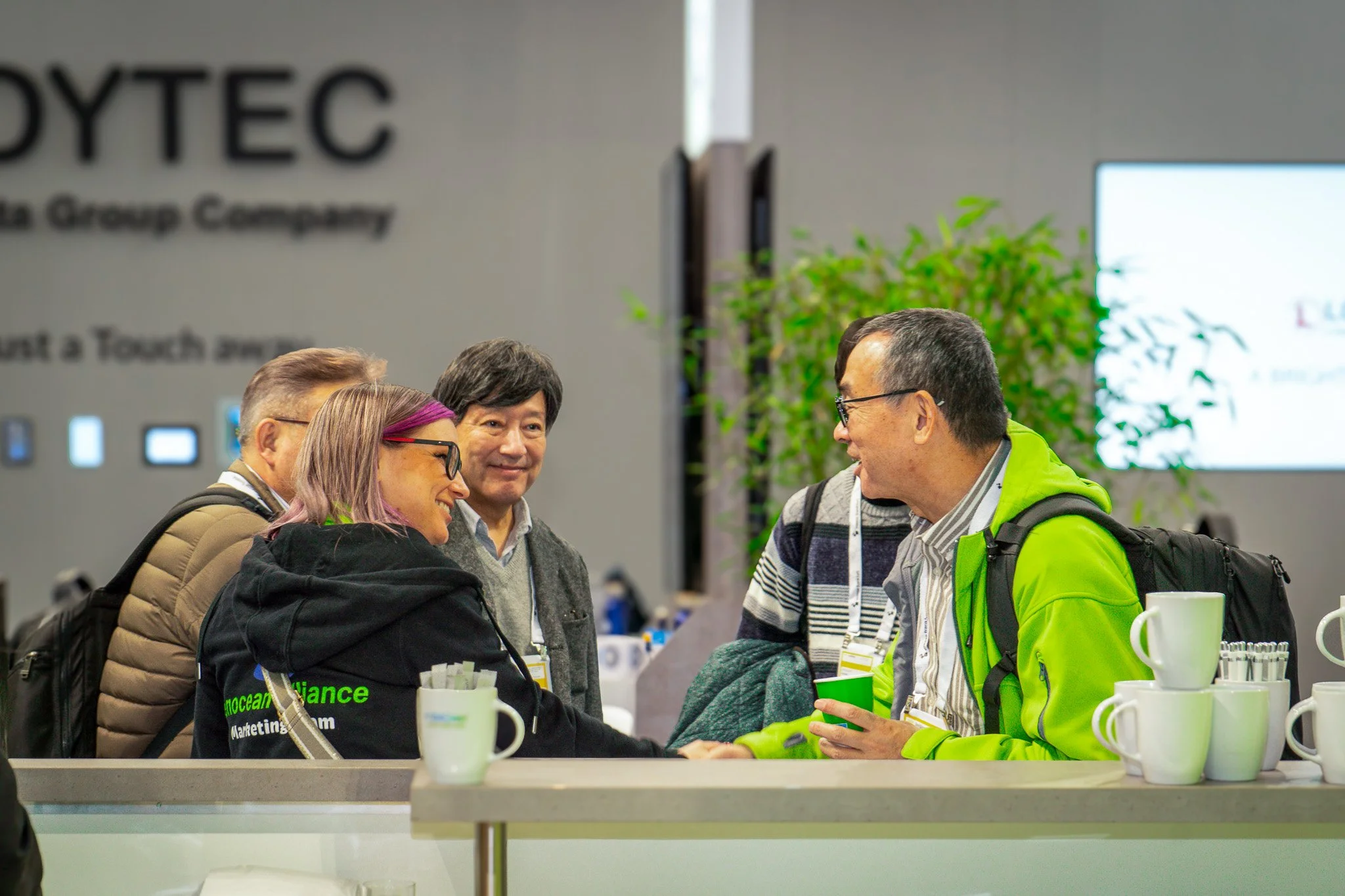 Business professionals networking at trade show booth