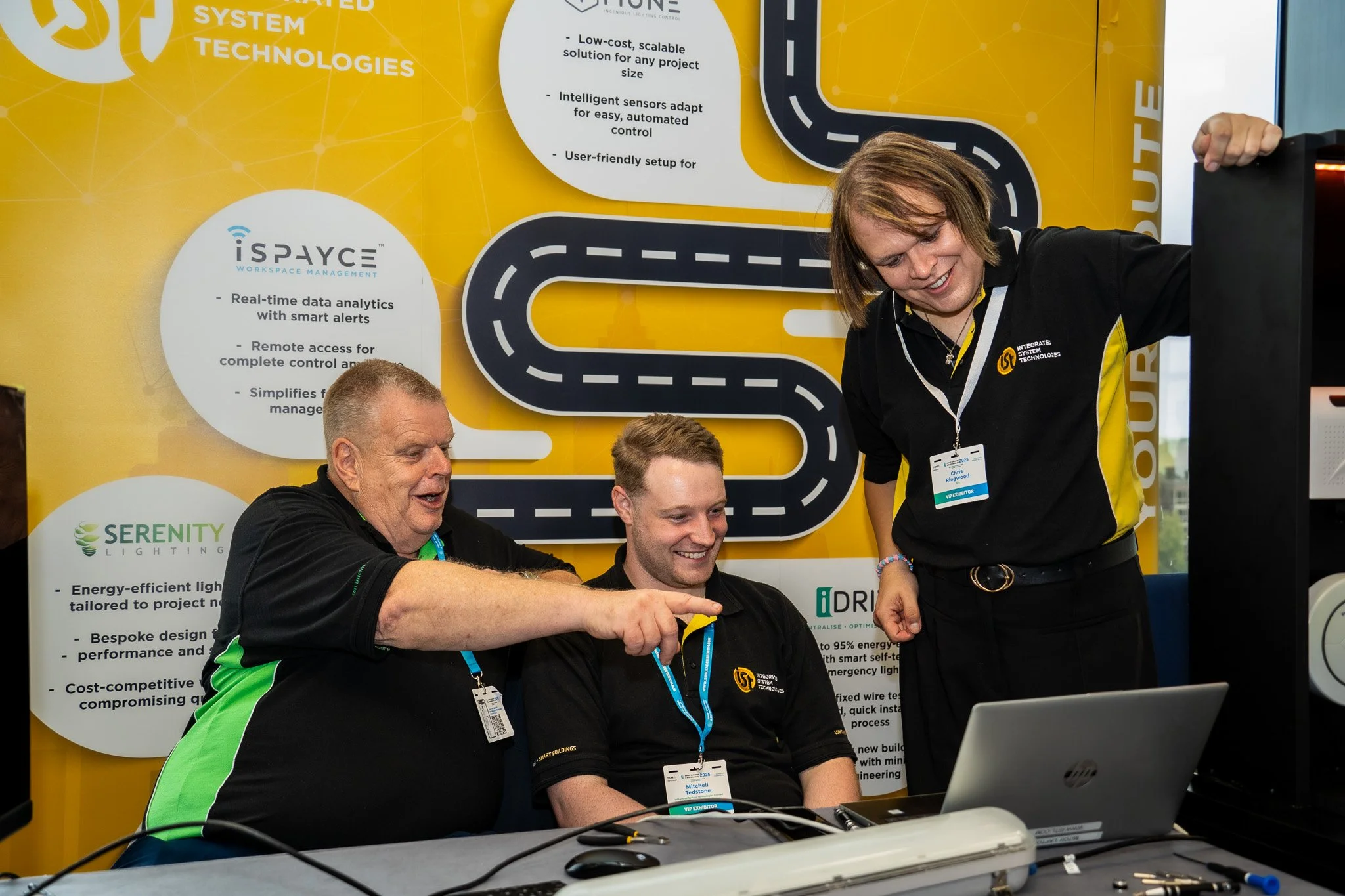 Team discussion at technology exhibition booth