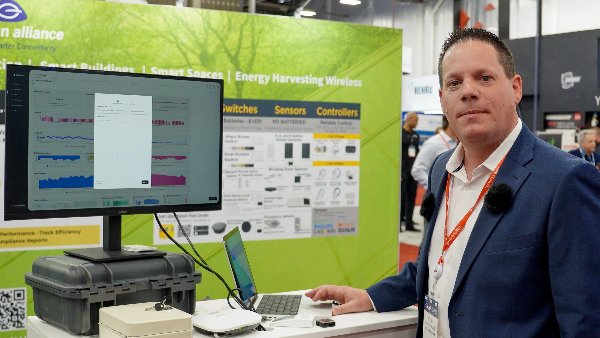Professional at exhibition booth with technology display