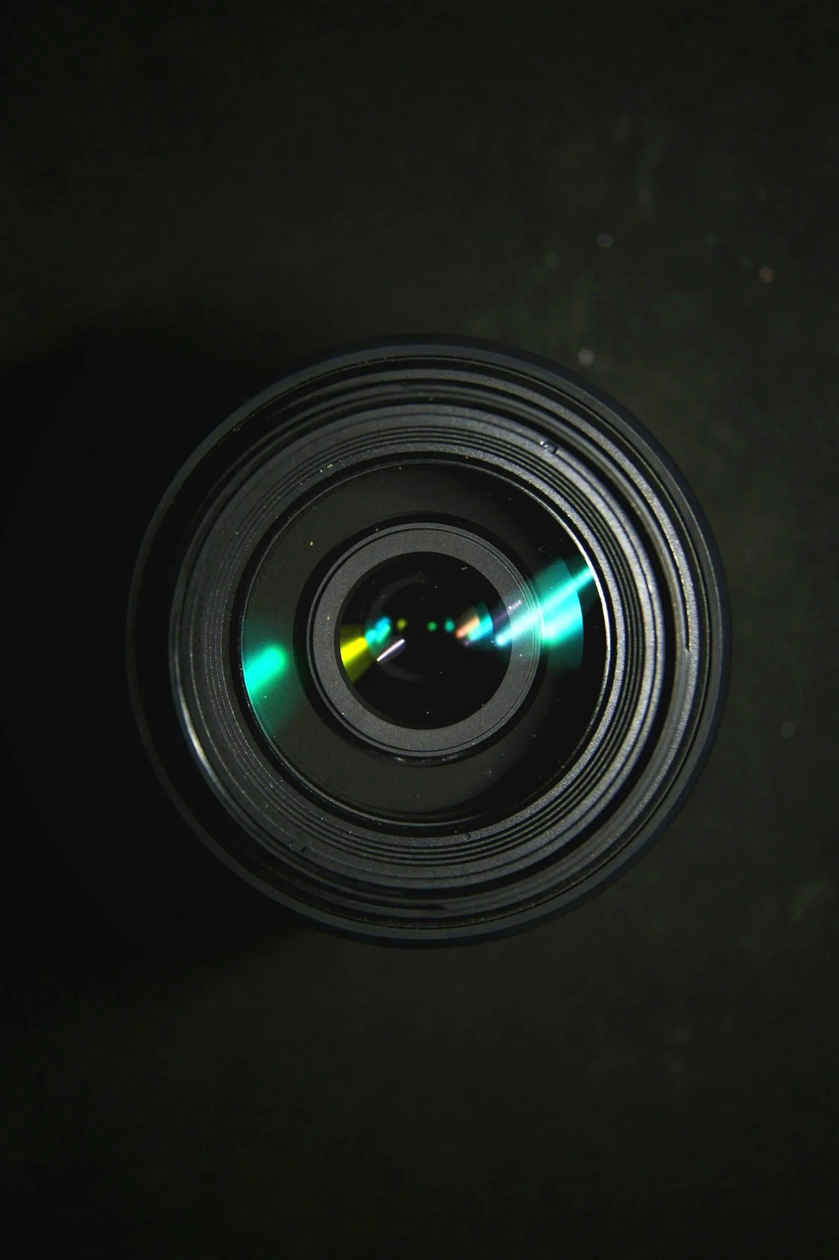 Close-up of camera lens with light reflection