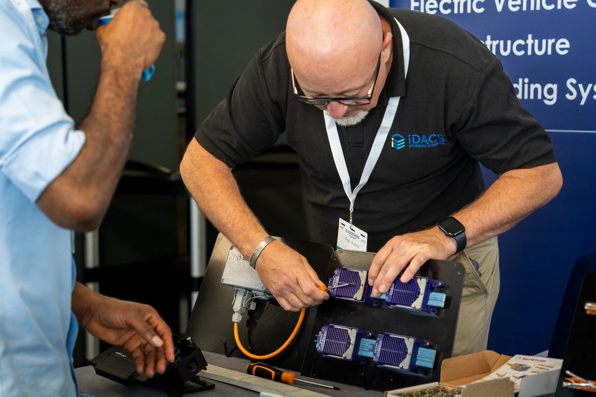 Technicians working on network equipment at trade show