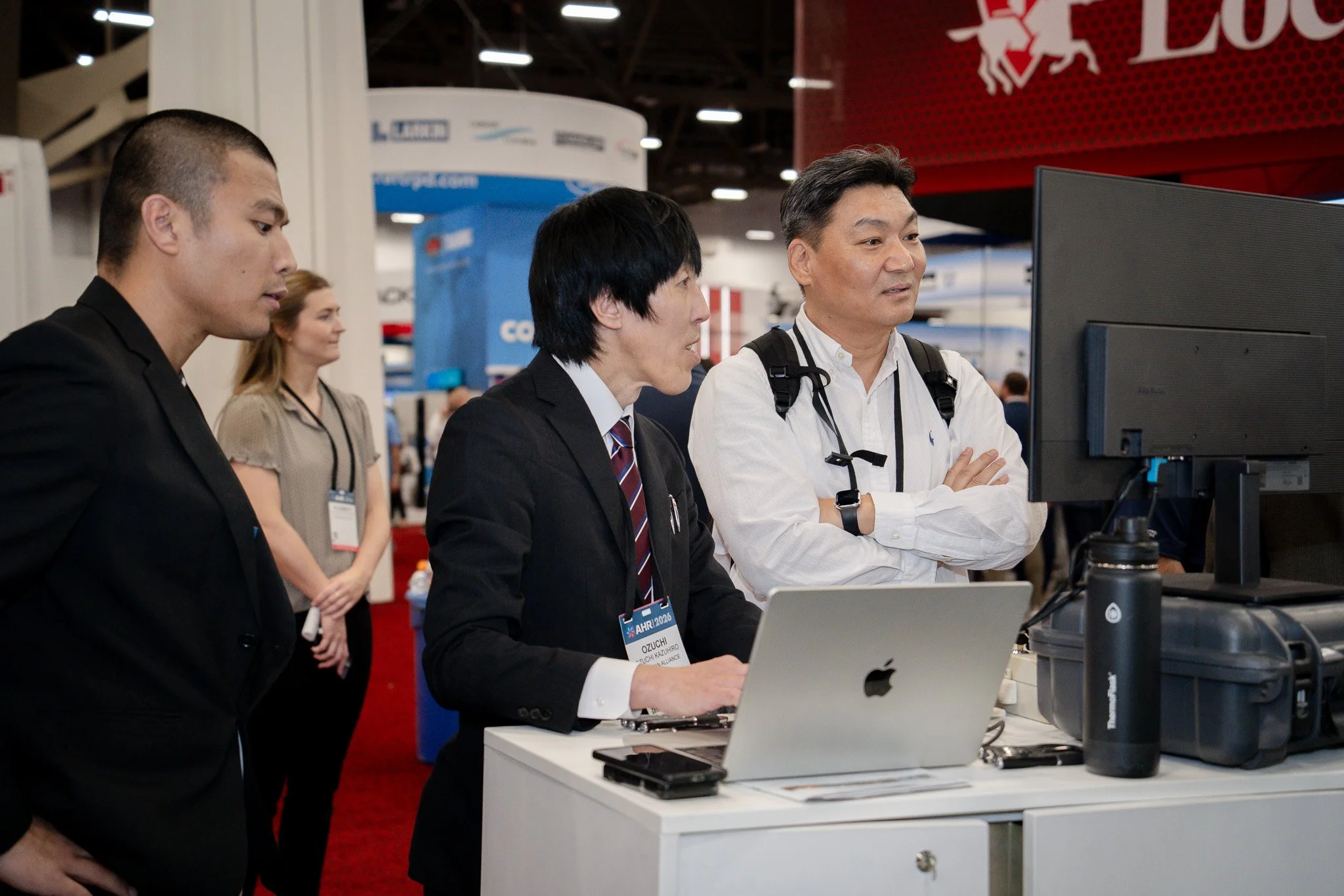 Team discussion at trade show booth
