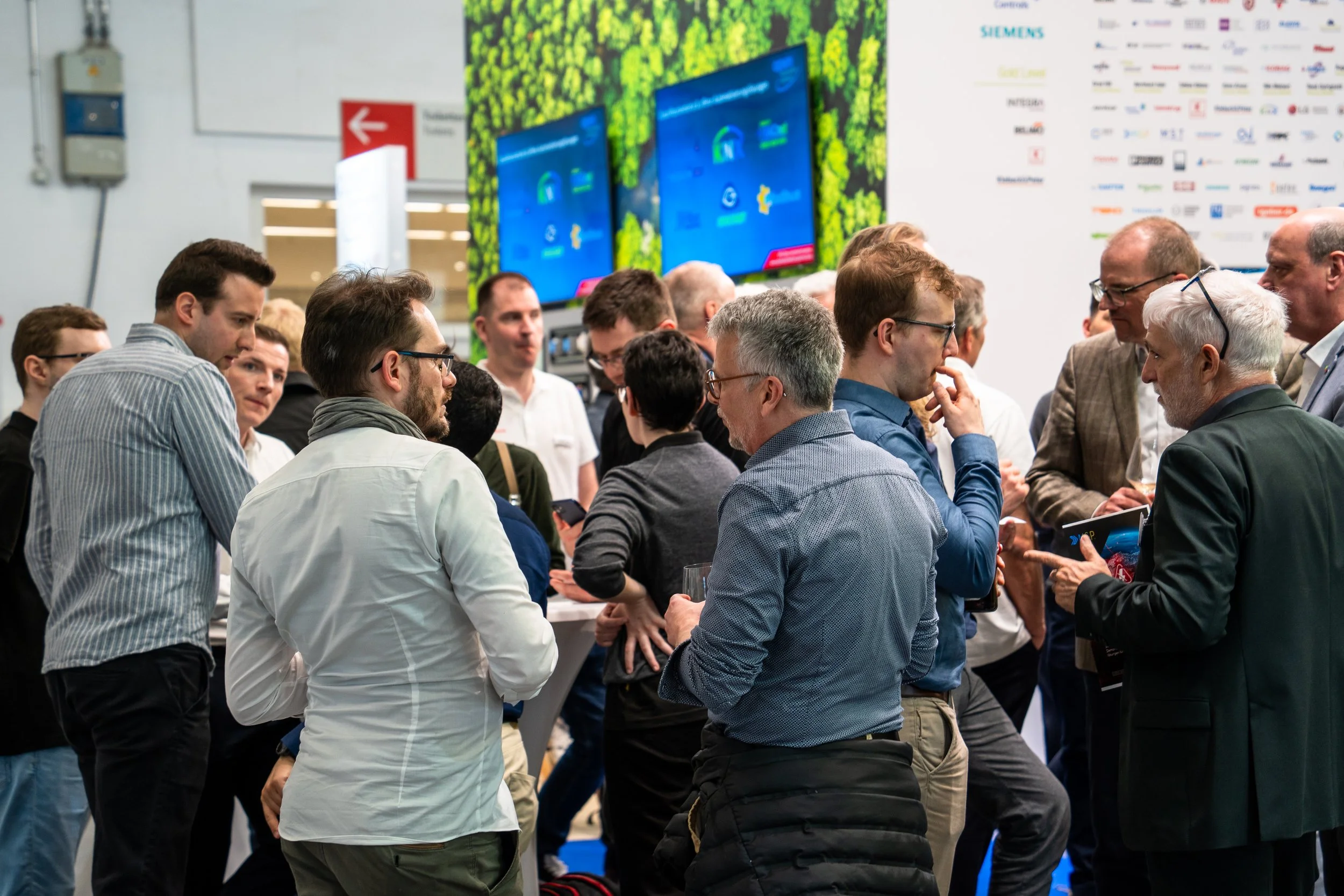 Attendees networking at industry conference