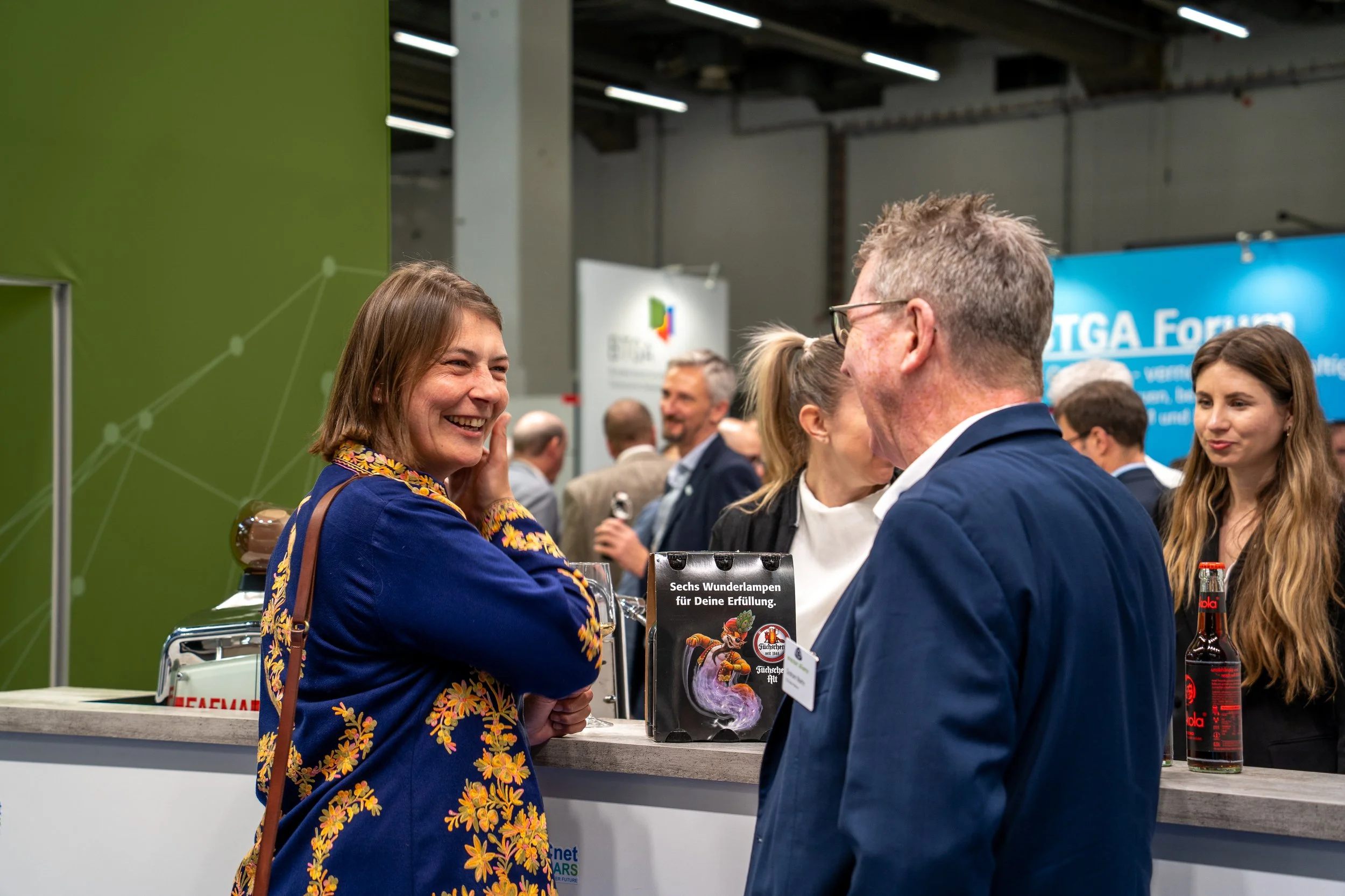 People networking at exhibition booth
