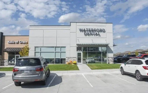Waterford Dental clinic with parking lot in front and a Nails of Grace salon on the side.